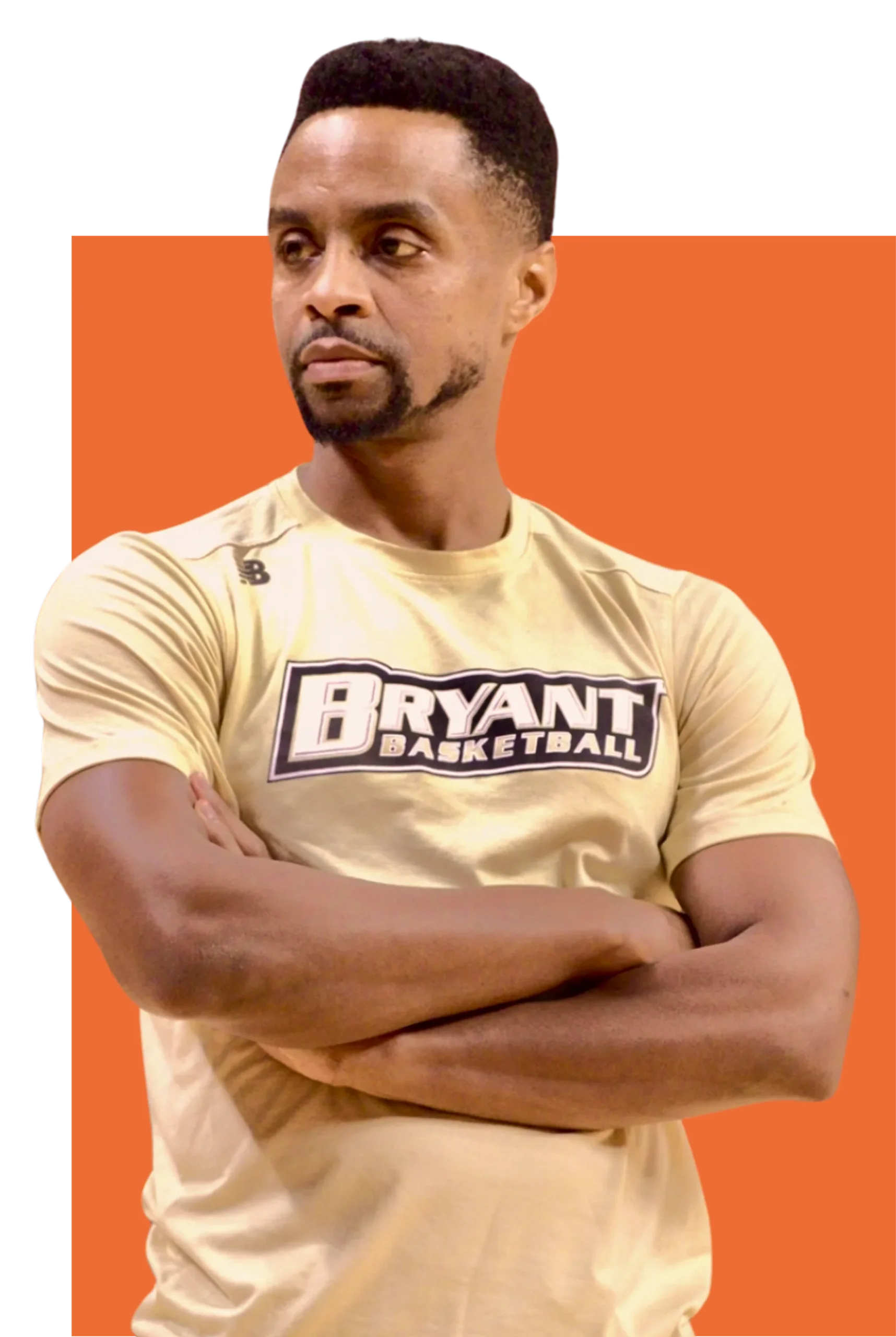 Basketball coach standing with arms crossed, wearing a Bryant Basketball training shirt, conveying confidence and leadership.