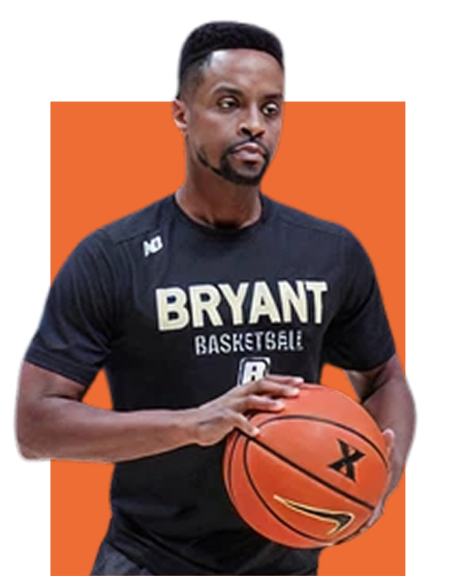Bryant Basketball coach holding a basketball while standing in a training pose, ready to instruct players.